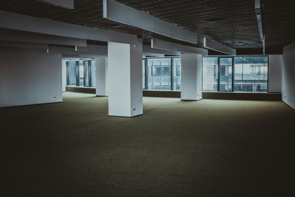 Empty bare shell office floor in India awaiting an interior fit-out, showing exposed structure before warm shell or plug-and-play conversion