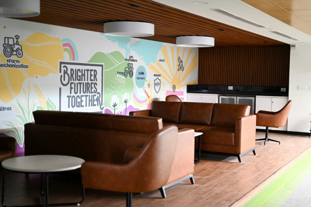 Contemporary office breakout lounge in a completed commercial fit-out, the end result of clearing landlord and fire NOC approvals in India
