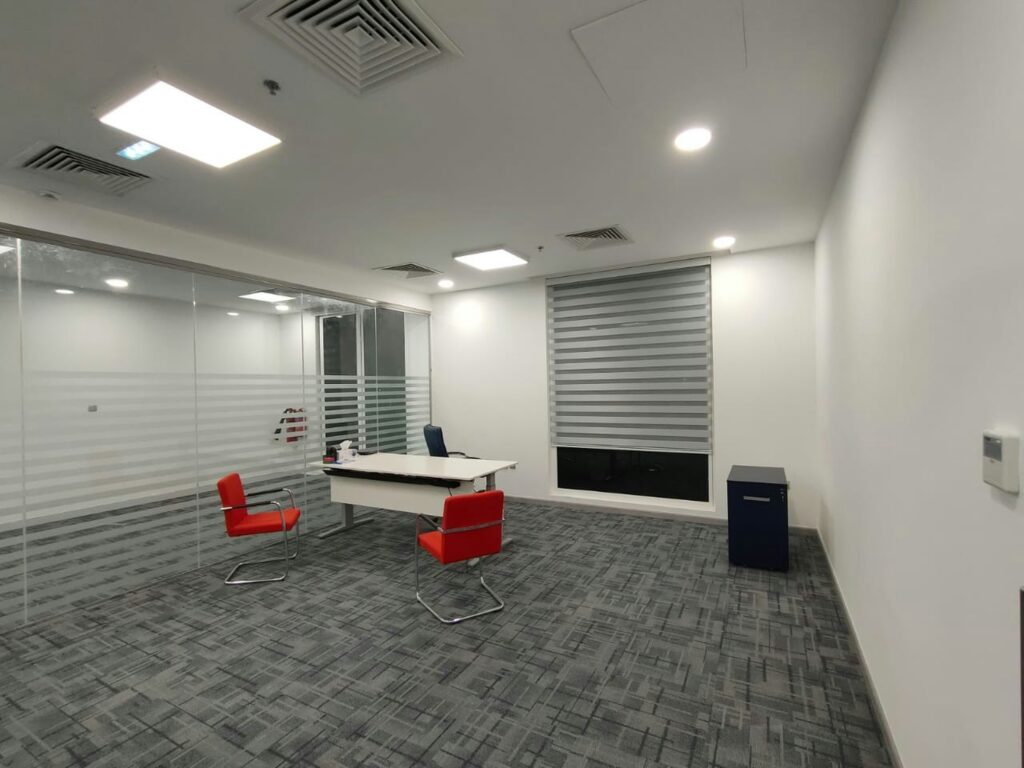 Empty completed office interior at fit-out handover stage, ready for snagging inspection before move-in