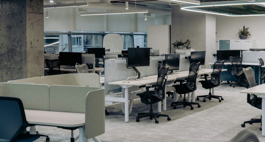 Open-plan office interior with carpet tile flooring across the workstation field, illustrating office flooring options in India